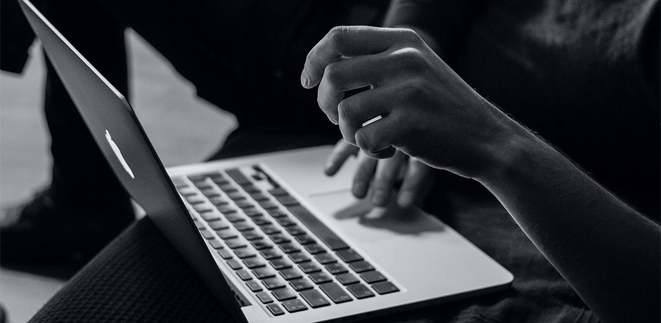 black white photo man working with laptop