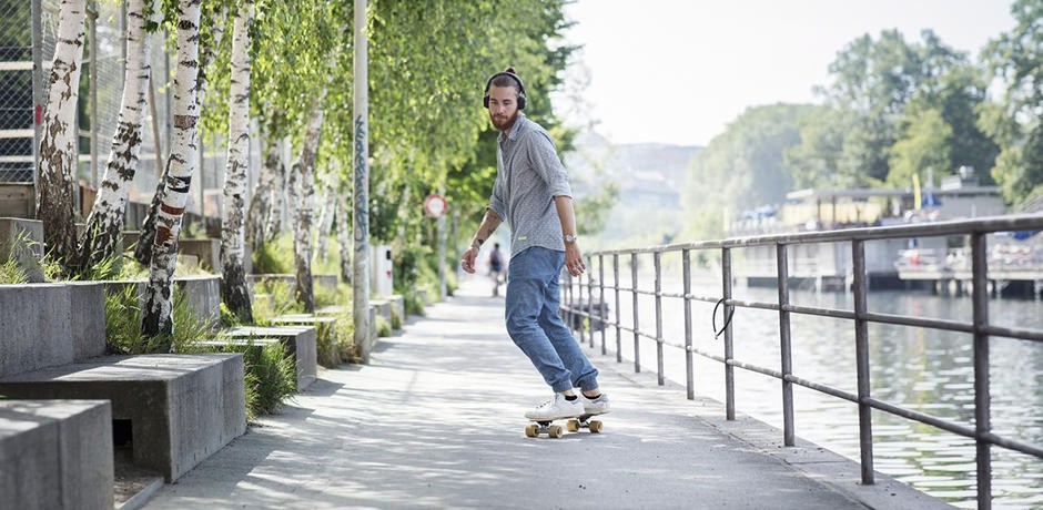 Man skatboarding along the river