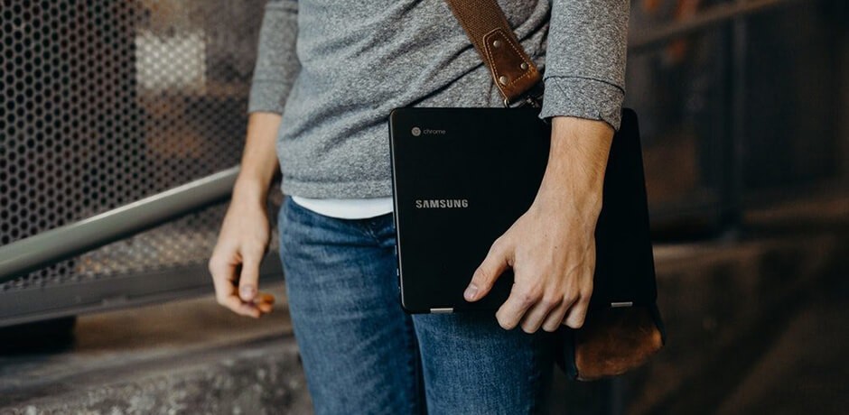 Man carries a Samsung laptop