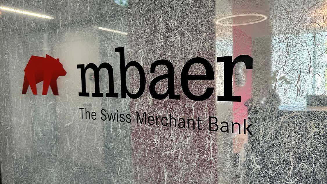 Image shows the MBaer logo