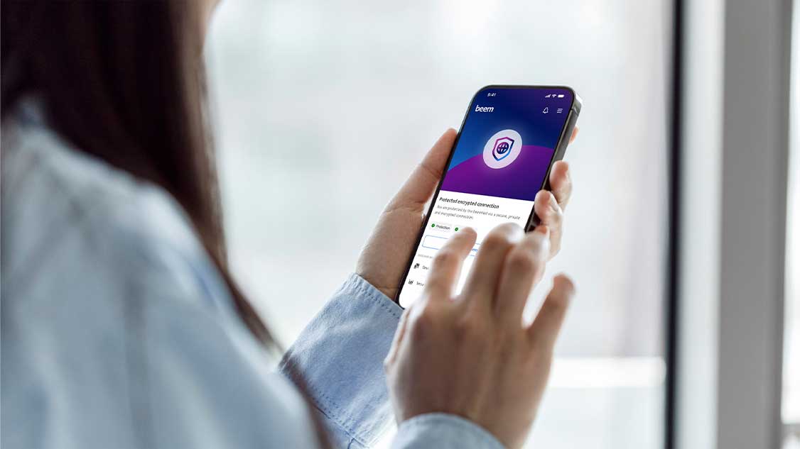 The image looks over the shoulder of someone using the beem app on their mobile.
