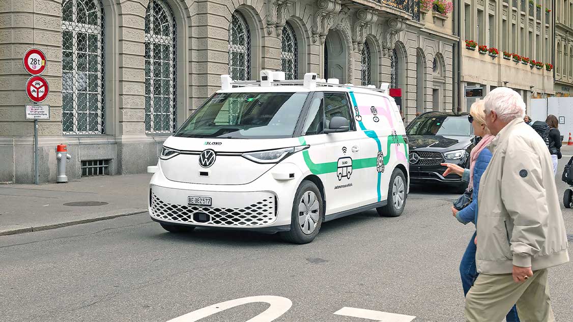 The picture shows Planzer's delivery van driving through a city