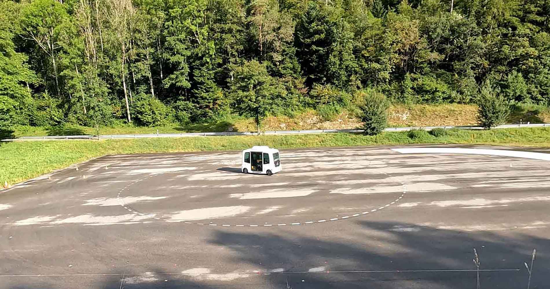 Photo shows a driverless test vehicle on a test track.