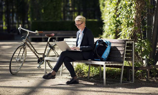 Woman on bench with laptop