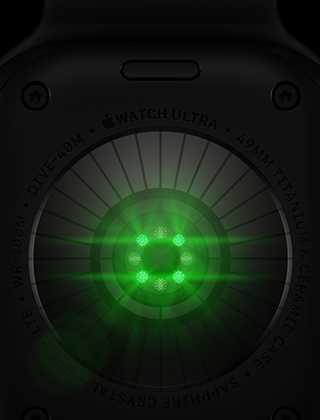Un Apple Watch Ultra 4 mostrato da dietro, cassa in titanio nero, una serie di sensori rotondi con luci LED verdi che pulsano